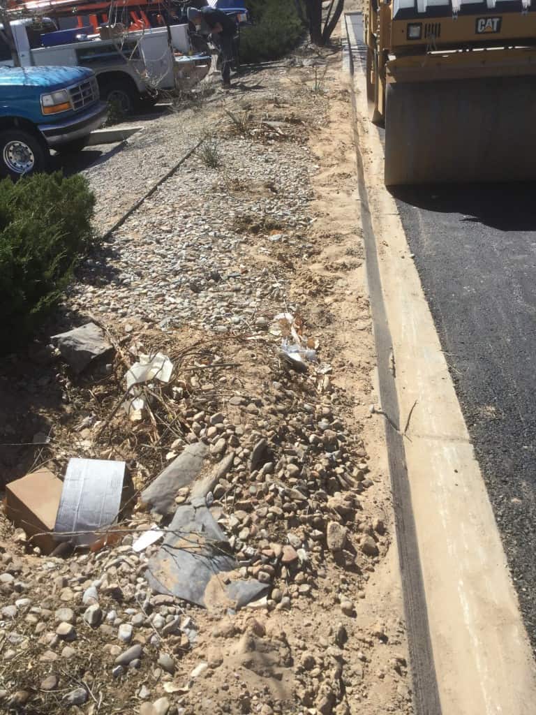 Landscaping-site-before-work-is-done-with-bulldozer-and-dump-truck-in-background